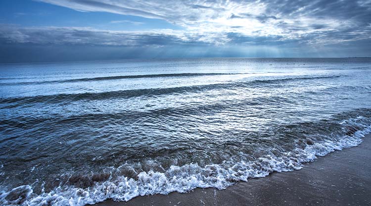 Image of beautiful clouds over the ocean, symbolizing how to protect your peace of mind