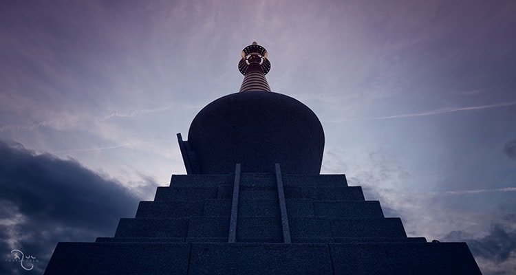 An image of a Buddhist stupa at sunset, symbolizing liberation