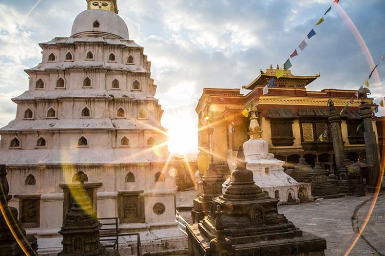 An image of a stupa and monastery in Nepal. What do Buddhists believe?