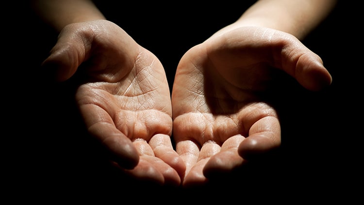 An image of open hands in generosity, a metaphor for exchanging self for others